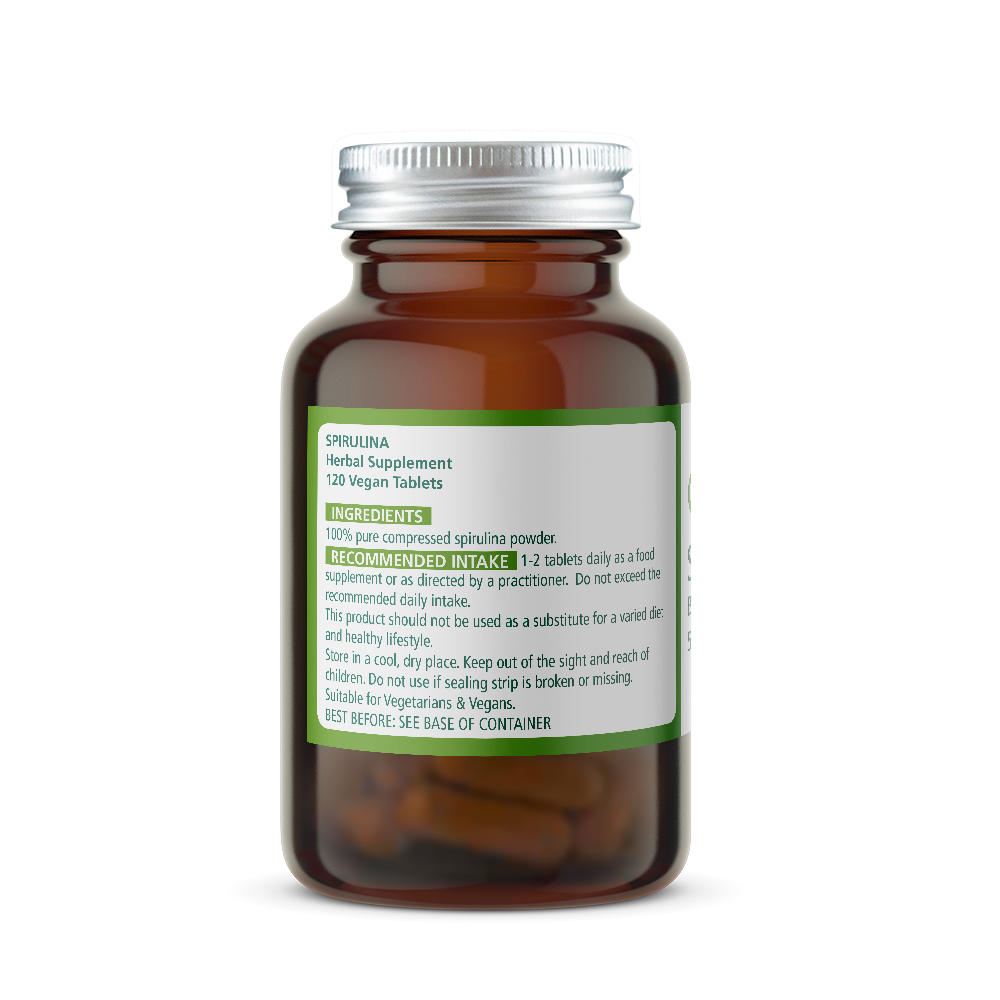 Amber glass spirulina supplement bottle with a silver cap on a white background