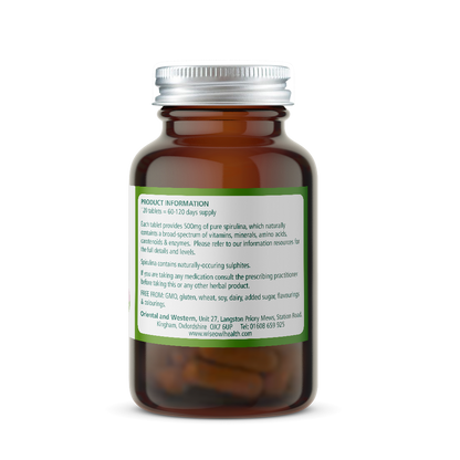Amber glass supplement bottle with a green label on a white background